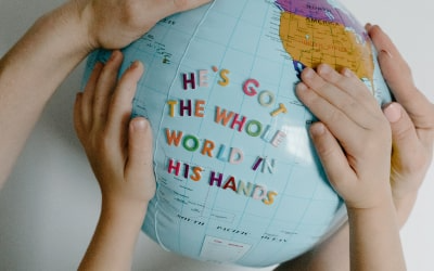 Children's hands on an inflatable globe